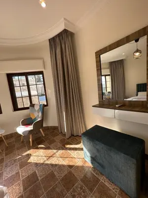 a living room with a bed and a mirror at 10 Antica jabalal-lwebdeh in Amman