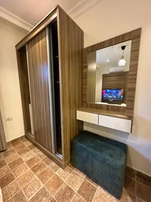 a living room with a television and a tiled floor at 10 Antica jabalal-lwebdeh in Amman