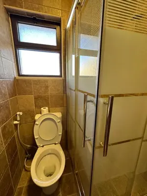 a bathroom with a toilet and a window and a shower at 11 Antica jabalal-lwebdeh in Amman