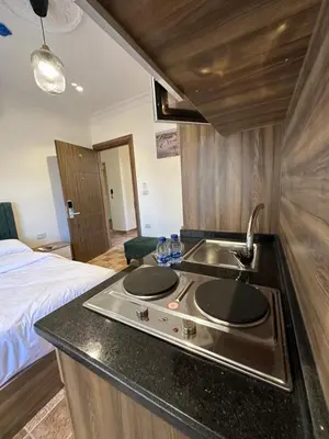 a kitchen with a sink and a bed in a room at 11 Antica jabalal-lwebdeh in Amman