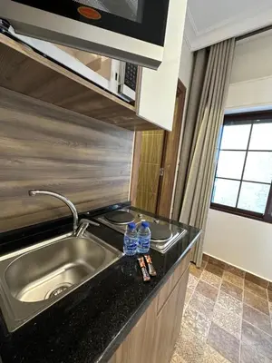 a kitchen with a sink and two water bottles on the counter at 11 Antica jabalal-lwebdeh in Amman