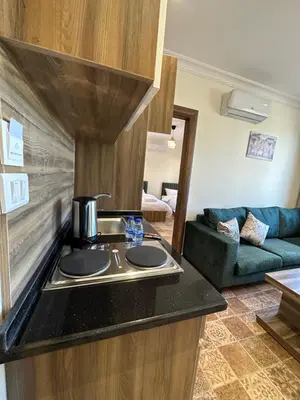 a kitchen with a sink and a stove in a room at 12 Antica jabalal-lwebdeh in Amman