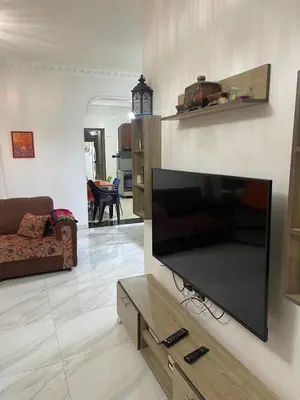 a living room with a large flat screen tv on a wall at Samar Home in Amman