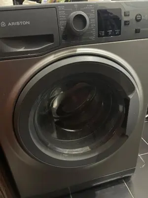 a washing machine with its door open in a kitchen at Samar Home in Amman