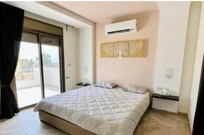 a bedroom with a large bed and a window at Private Pool - Relax Chalet Deadsea in Amman