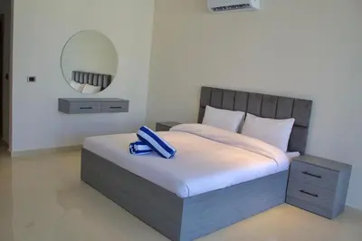 a bedroom with a bed with a blue ribbon on it at Florya Villa by Seahorse in Amman
