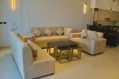 a living room with two couches and a table at Florya Villa by Seahorse in Amman