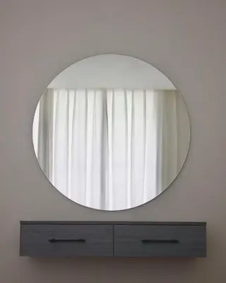 a mirror on a wall above a dresser at Florya Villa by Seahorse in Amman