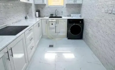 a white kitchen with a washing machine in it at sweetsoul in Amman