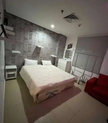 a bedroom with a large bed and a stone wall at sweetsoul in Amman