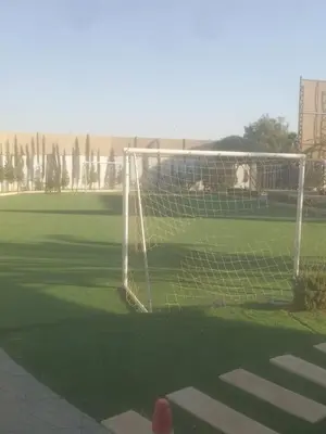 a soccer goal in the middle of a field at Rosario Farm Home in Amman