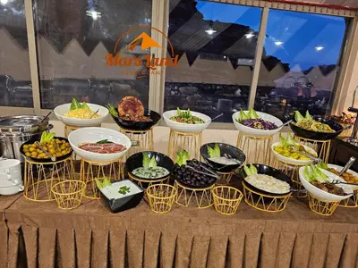 a buffet of food on a table with bowls of food at Mars Land Luxury Camp in Wadi Rum
