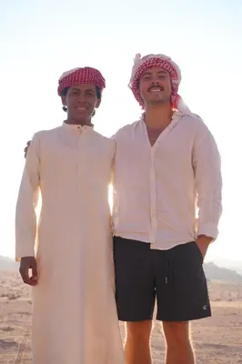 two men standing next to each other in the desert at Bedouin cave wadi rum campsite in Wadi Rum