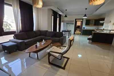 a living room with a couch and a table at Apartment the most upscale neighborhoods of Amman in Amman