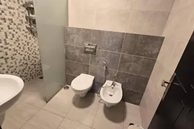 a bathroom with a toilet and a sink at Apartment the most upscale neighborhoods of Amman in Amman
