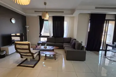 a living room with a couch and a table at Apartment the most upscale neighborhoods of Amman in Amman