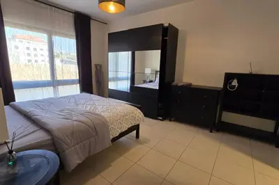 a bedroom with a bed and a large mirror at Apartment the most upscale neighborhoods of Amman in Amman