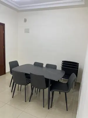 a black table and chairs in a room at Charming modern 2BD in Abdoun in Amman