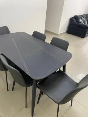 a black table and chairs in a room at Charming modern 2BD in Abdoun in Amman