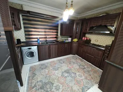 a kitchen with a washing machine and a sink at شقة مفروشة مجهزة بكل الخدمات in Irbid