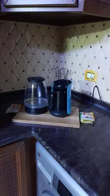 a kitchen counter top with a toaster on a cutting board at شقة مفروشة مجهزة بكل الخدمات in Irbid