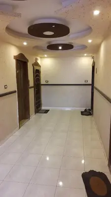 a large room with a white floor and a ceiling at شقة مفروشة مجهزة بكل الخدمات in Irbid