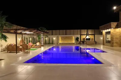 a swimming pool with blue lights in a house at Sunrise Villa in Sowayma