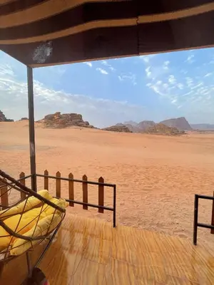 a hammock in the desert with a view of the desert at Ahmad and Fatima's Traditional Bedouin Camp in Wadi Rum