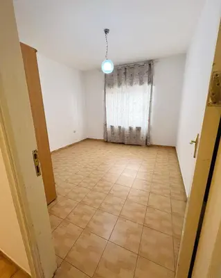 an empty room with a large window and a tiled floor at Furnished Apartment for Rent in Abdoun 200sqm in Amman