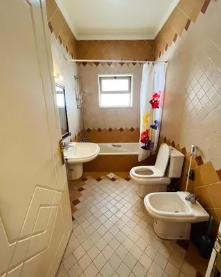 a bathroom with two toilets and a sink at Furnished Apartment for Rent in Abdoun 200sqm in Amman