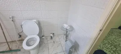 a small bathroom with a toilet in a room at Nights of the Orient Guesthouse in Al Salt