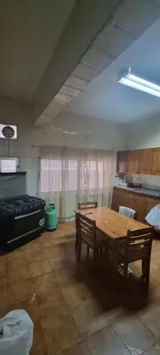 a kitchen with a wooden table and a stove at Nights of the Orient Guesthouse in Al Salt