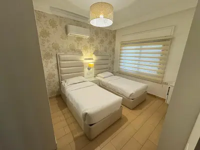 a bedroom with two beds and a window at Cozy apt Grt location for long and short stay in Amman