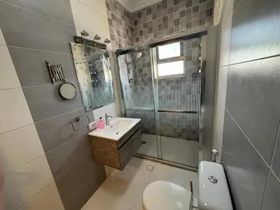 a bathroom with a toilet and a sink and a shower at Cozy apt Grt location for long and short stay in Amman