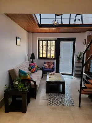 a living room with a couch and a table at Loft Apartment Jabal Amman B in Amman