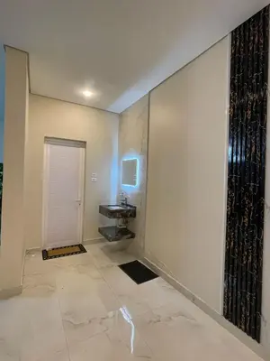 a bathroom with a sink next to a door at منتجع الحور in Ajloun