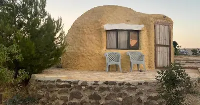 a couple of chairs sitting outside of a house at Al -Nawatef Eco Lodge- Dana Nature Reserve in Dana