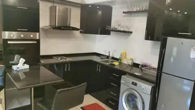 a kitchen with a refrigerator and a dishwasher in it at Apartment in Amman with wow furniture in Amman