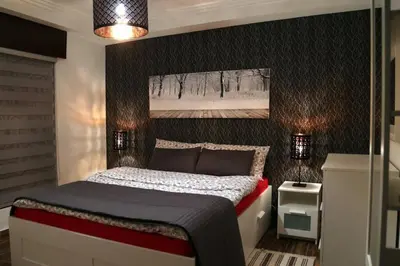 a bedroom with a bed with a black wall at Apartment in Amman with wow furniture in Amman
