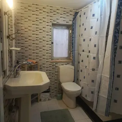 a bathroom with a white toilet and a sink at B Beitna in Amman