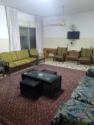 a living room with couches and a coffee table at ALOTAIBI bulding # 6 in Amman
