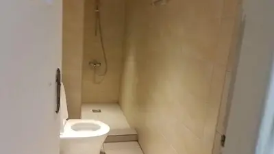 a bathroom with a shower and a toilet at Jordan River hotel in Amman