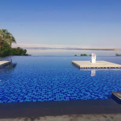 a pool with a no swimming sign in the water at E23 Luxury - Full Sea view-Samra Resort in Sowayma