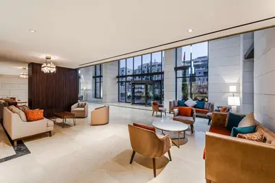 a lobby with couches and chairs in a building at Doubletree By Hilton Amman Hotel & Residences in Amman