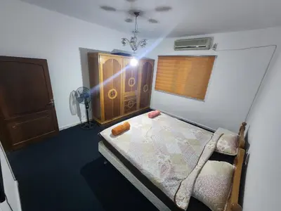 a small bedroom with a bed and a window at Artemis Hotel in Jerash