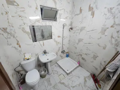 a bathroom with a toilet and a sink and a mirror at Artemis Hotel in Jerash