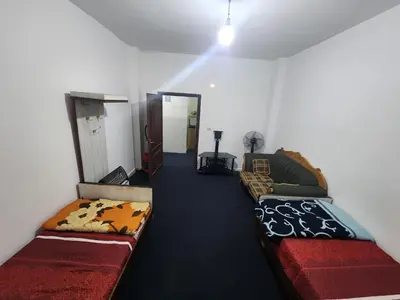 a living room with two couches in a room at Artemis Hotel in Jerash