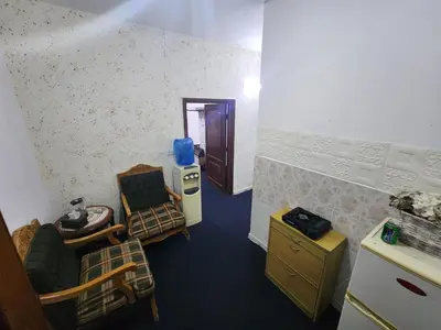 a room with a table and chairs and a kitchen at Artemis Hotel in Jerash