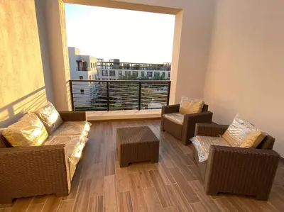a living room with two couches and a large window at Lovely 2-Bedroom with pool in the heart of Aqaba in Aqaba