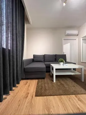 a living room with a couch and a table at Amman Central Cozy Apartment in Amman